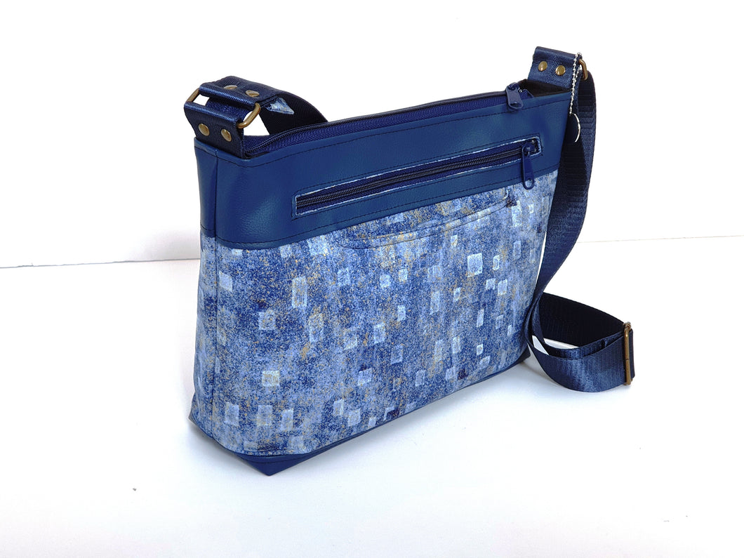 Multi pocket, medium sized, fabric and vegan leather cross body purse
