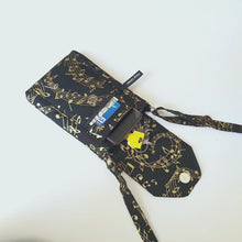 Load and play video in Gallery viewer, Cell phone purse - black fabric with metallic gold music design
